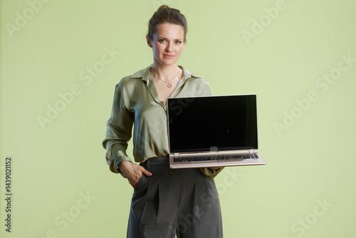 Obraz na płótnie Confident businesswoman holding laptop w salonie