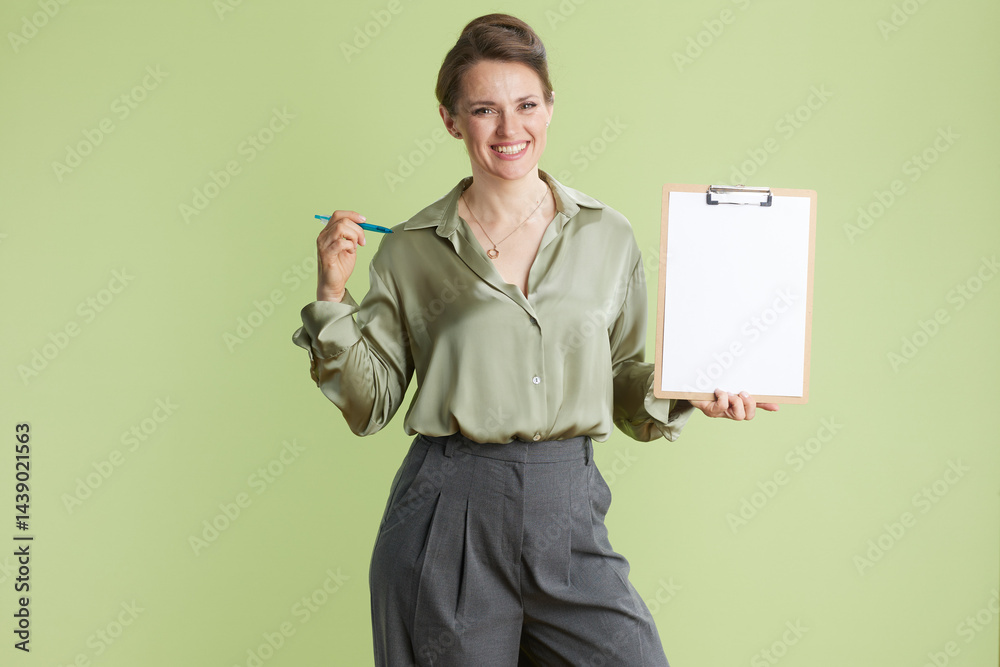 Smiling businesswoman with clipboard and pen