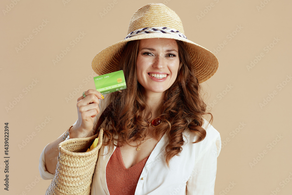 happy elegant woman in blouse and shorts isolated on beige