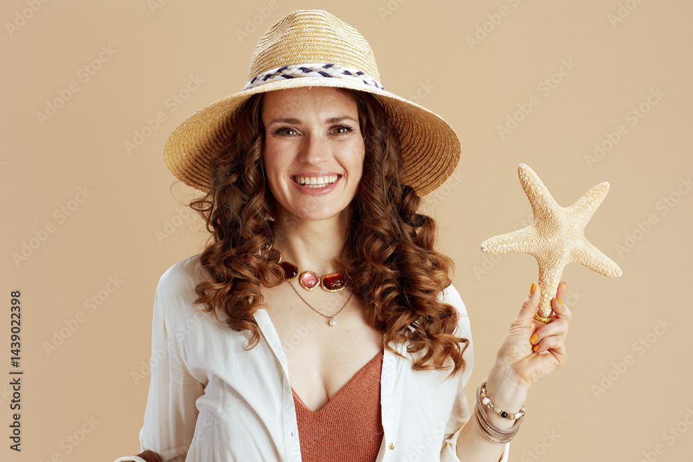 smiling elegant woman in blouse and shorts on beige