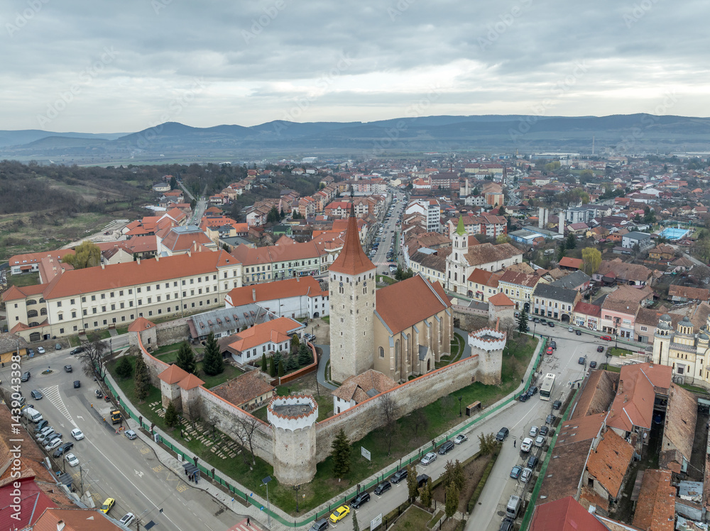 Aerial view of Aiud Nagyenyed fortified protestant church in Romania with walls and towers in the middle of the town