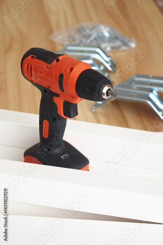 Wallpaper Mural Power drill resting on wooden planks amid construction tools Torontodigital.ca