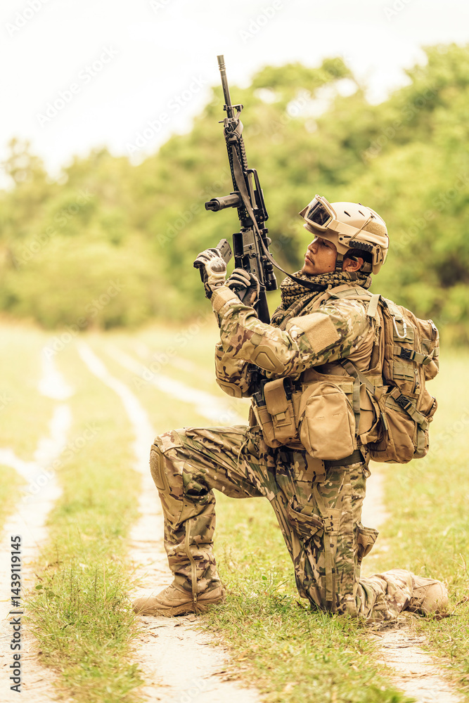 Dressed in full camouflage, the soldier remains still for several moments, scanning the terrain with sharp eyes, gathering information and planning his next move... Dressed in full camouflage, the soldier remains still for several moments, scanning the terrain with sharp eyes, gathering information and planning his next move...