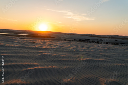 Obraz na płótnie Beautiful view of sandy desert at sunset. A bright yellow orange dawn in the desert. w salonie