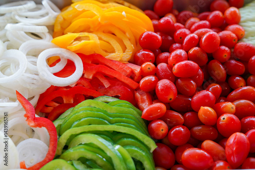 Obraz na płótnie Sliced onion, yellow bell pepper, red bell pepper, grape tomato, and green bell pepper arranged in colorful, fresh, healthy salad mix w salonie