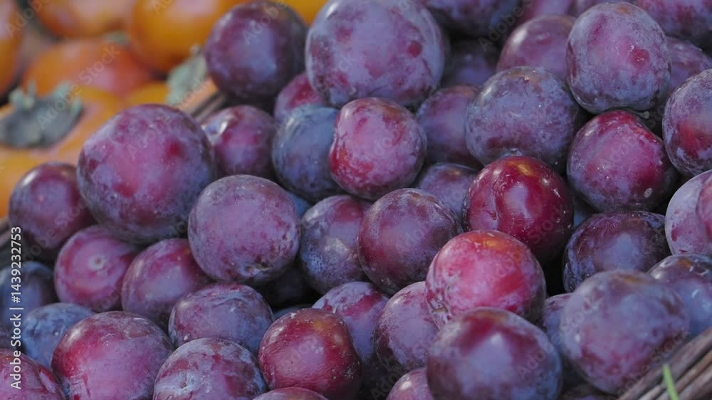 Freshly harvested plums at a vibrant market stand