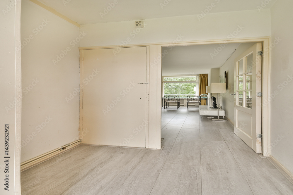Obraz premium Spacious indoor area featuring a clean, modern aesthetic with neutral tones and natural light streaming through large windows.