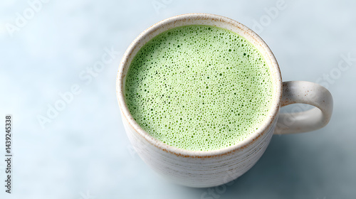 Obraz na płótnie Top-down close-up photo of a perfectly made matcha latte.
w salonie