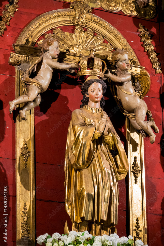Fototapeta premium Statue (19th century) of Coronation of the Virgin Mary, Mother of God, by angels.