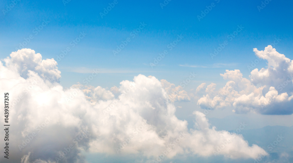 Image of white beautiful clouds above blue sky style of realistic atmospheres, aerial view Image of white beautiful clouds above blue sky style of realistic atmospheres, aerial view