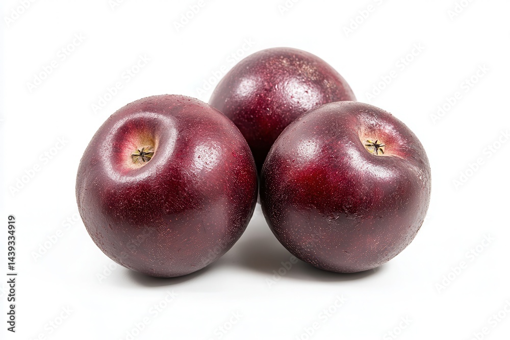 Fototapeta premium Three glossy red apples arranged in a cluster on a clean white background