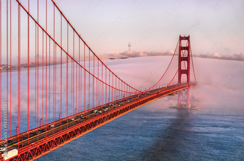 Fototapeta premium Golden Gate Bridge Shrouded in Mystical Fog Overlooking the Bay in San Francisco, California