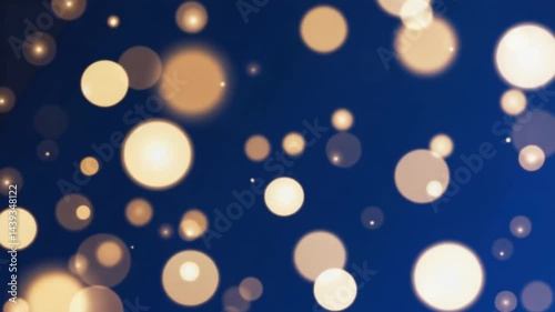 Floating Golden Light Orbs Against Blue Background Slow Motion