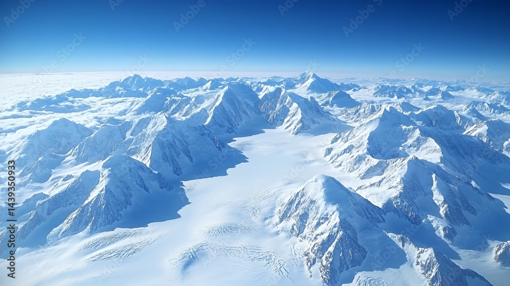 Fototapeta premium Majestic snow-covered mountains under a clear blue sky from above.