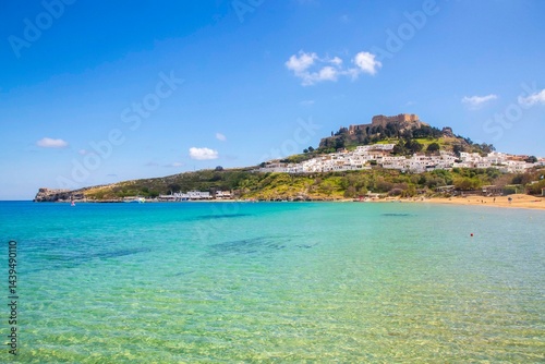 Fototapeta Naklejka Na Ścianę i Meble -  Rhodes, Greece. Lindos small whitewashed village and the Acropolis, scenery of Rhodos Island at Aegean Sea.