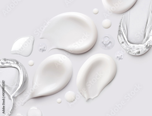 samples of cosmetic care products smear of cream and gel texture on a light background