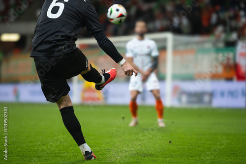 Obraz na płótnie Soccer player kicks the ball during football match. Opponent player in the wall. w salonie