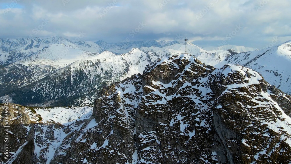 Snow capped mountain peak rocks glacier view from above Zakopane Poland