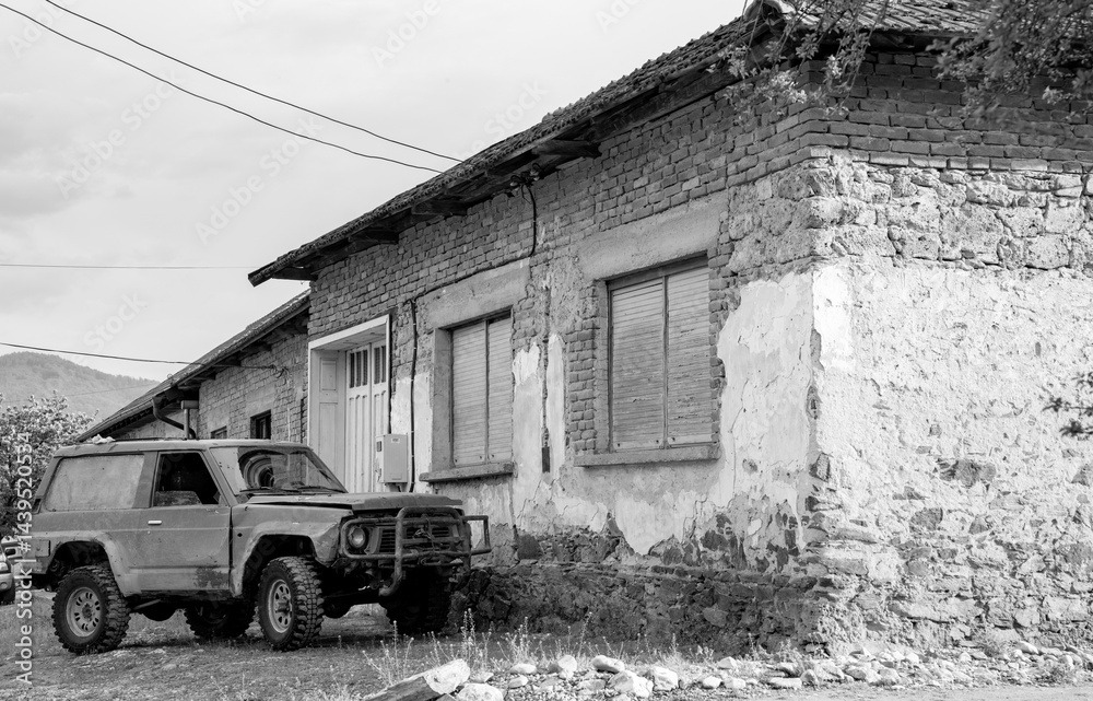 Obraz premium old abandoned car and house, black and white