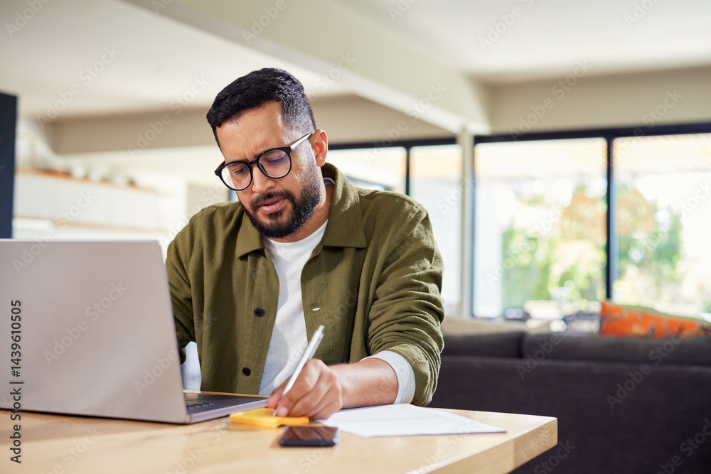 Fototapeta premium Businessman working on laptop at home with copy space
