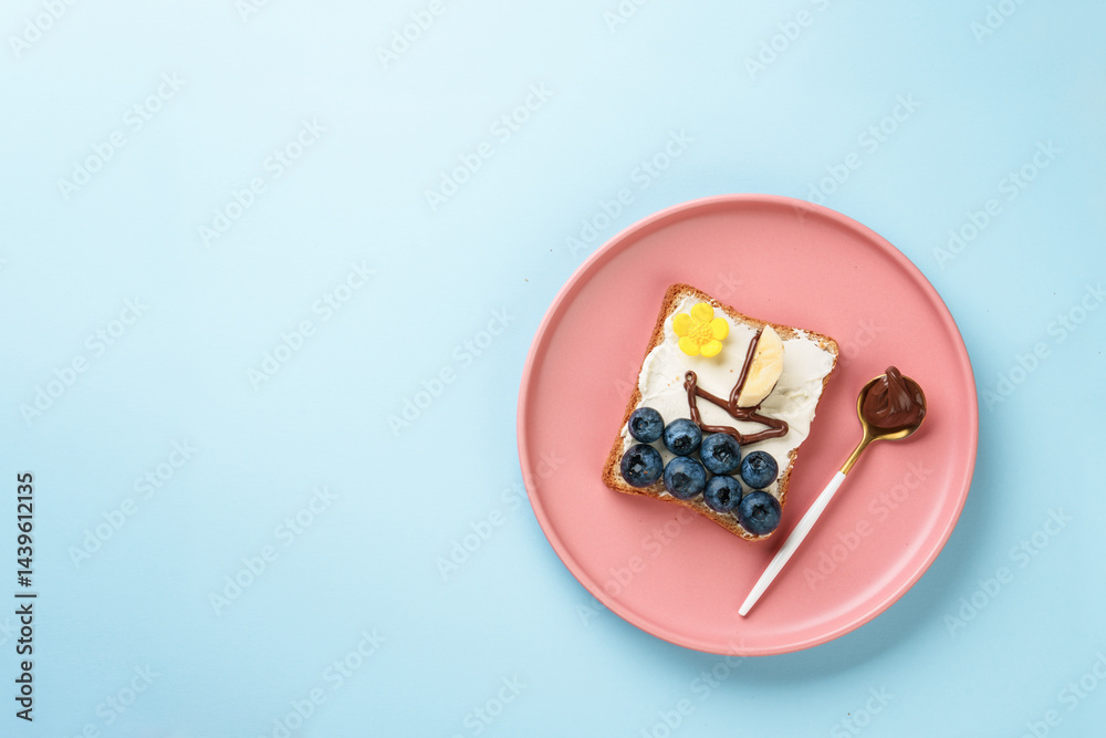 Summer food concept. Toast with berry and chocolate. Boat in the sea and sun. Flat lay image.