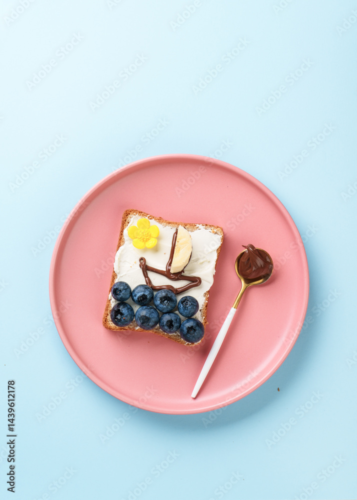 Sweet toast with blueberry and chocolate paste. Flat lay on blue.