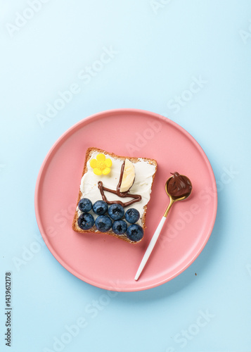 Obraz na płótnie Sweet toast with blueberry and chocolate paste. Flat lay on blue. w salonie