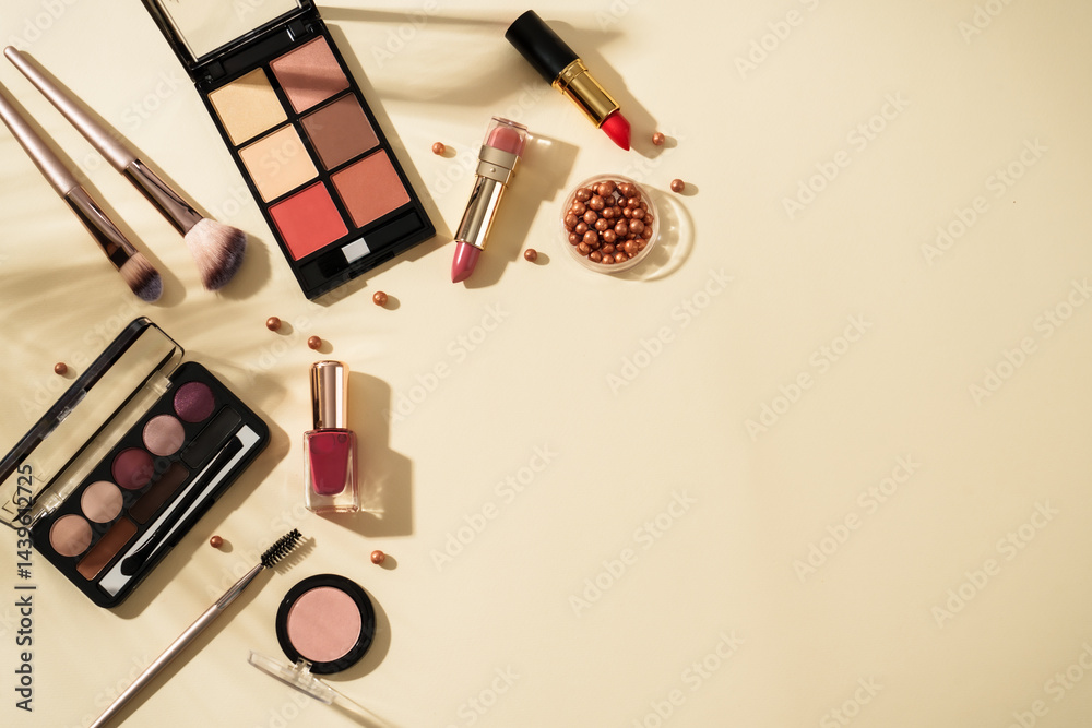 Make up beauty products at pastel background with hard shadows. Top view image with copy space.