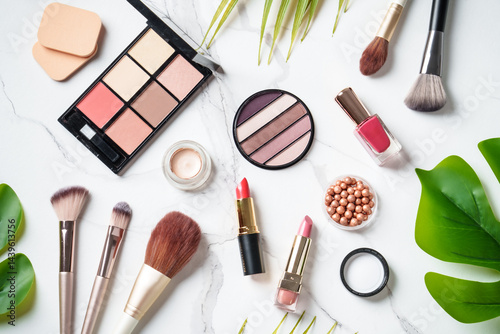 Obraz na płótnie Cosmetic products on white background. Palette, brushes and lipsticks. Top view with copy space. w salonie