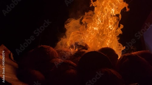 Fire blazing on coconut shells at night. Flames Burning. Detail of fire on black background