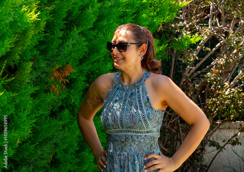 portrait of beautiful young woman in sunglasses in the garden