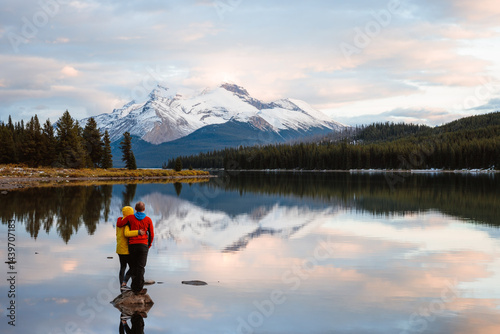 Adult couple at Maligne lake at sunset, Jasper National Park, Canada