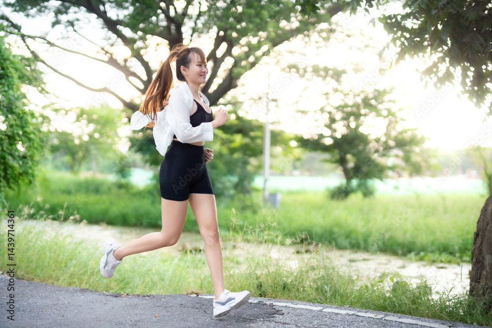 Portrait of beautiful asian Young woman in white robe wearing sportswear jogging working out outside. training on public equipment in outdoor at park. concept Exercise Healthy lifestyle.