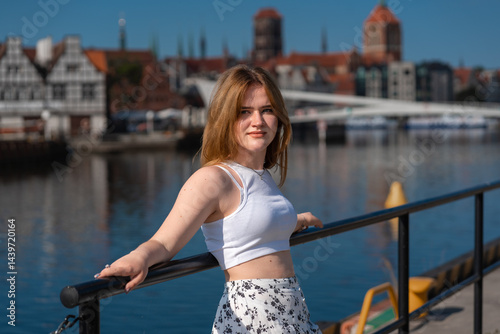 Obraz na płótnie girl in a white hat on the background of the city of Gdansk Poland Europe w salonie