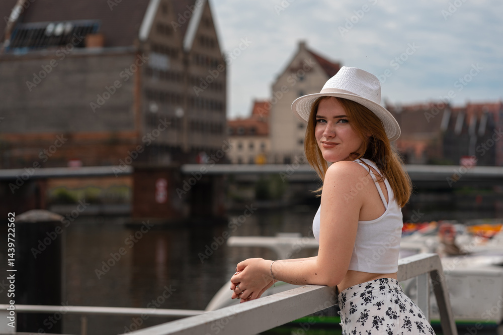 girl in a white hat on the background of the city of Gdansk Poland Europe