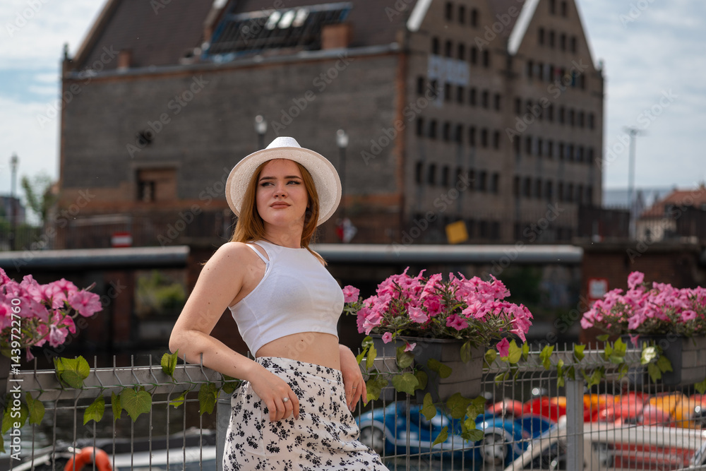 Fototapeta premium girl in a white hat on the background of the city of Gdansk Poland Europe
