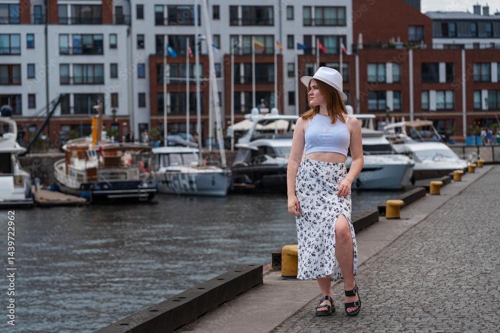 girl in a white hat on the background of the city of Gdansk Poland Europe