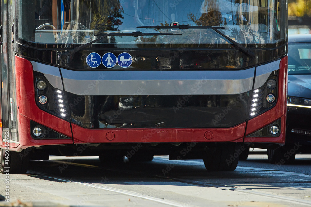 Red bus for public transportation on city streets.