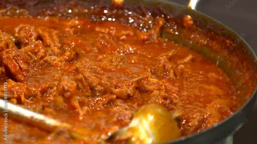 Spicy braised chicken feet in sauce simmering in a pot Spicy braised chicken feet in sauce simmering in a pot
