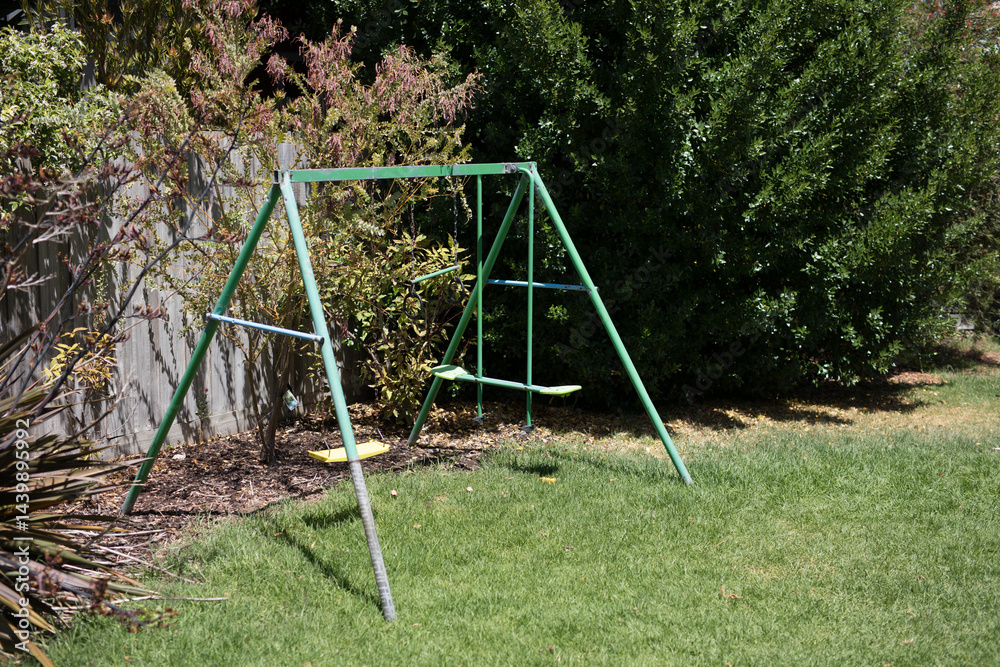 Swing set in backyard Swing set in backyard