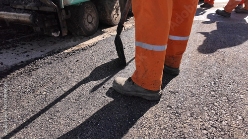 Obraz na płótnie Construction workers working on a new asphalt layer on a public street. w salonie