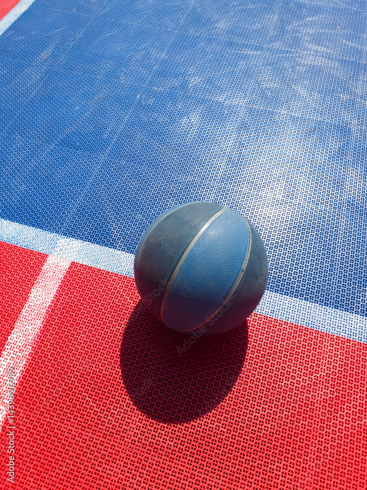 Basketball ball on a outdoor court.
