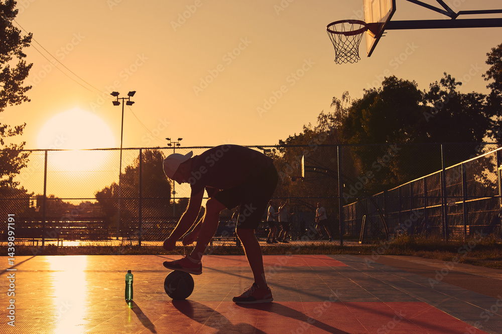 Man with basketball ball on a public court.