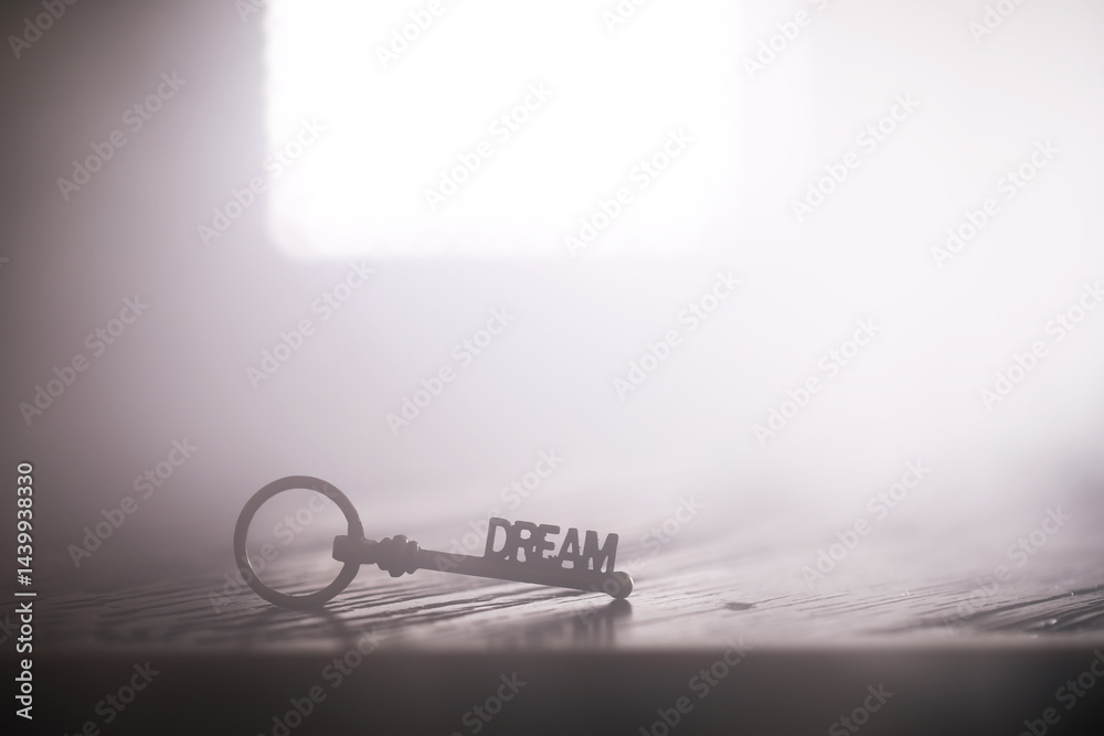 Dream Key on Wooden Surface with Bright Light in Background - Symbolizing Imagination and Potential
