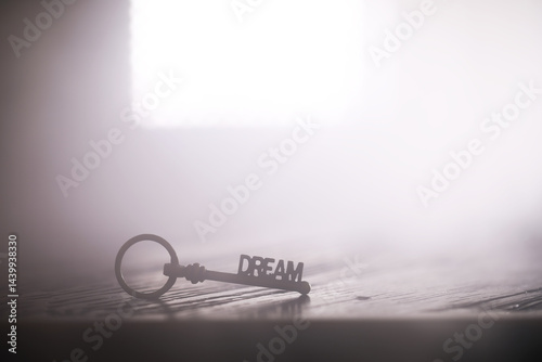 Obraz na płótnie Dream Key on Wooden Surface with Bright Light in Background - Symbolizing Imagination and Potential w salonie