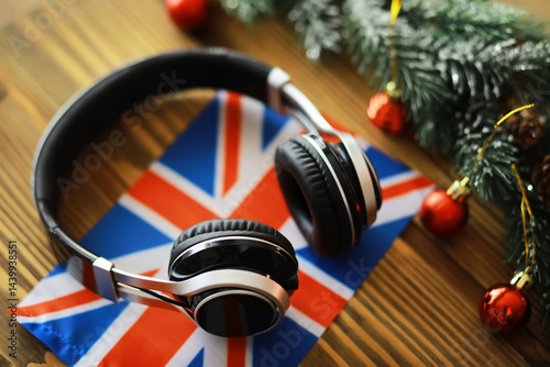 Obraz na płótnie Christmas-Themed Headphones on Union Jack Flag with Festive Decorations w salonie