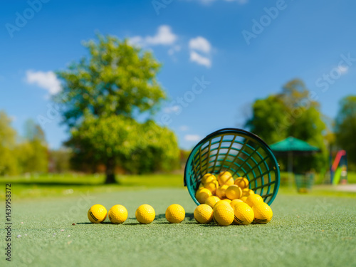 Obraz na płótnie Golf balls and storage basket. Sports and hobbies. Sports competitions and active recreation. Individual and team game. Golf ball on a blurred background. w salonie