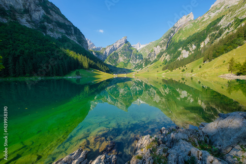 Obraz na płótnie Seealpsee, Switzerland. Lake and reflections on the water surface. Mountain landscapes in summer. Place for mountain hiking, travel and vacation. Wallpaper, postcard, photo. w salonie