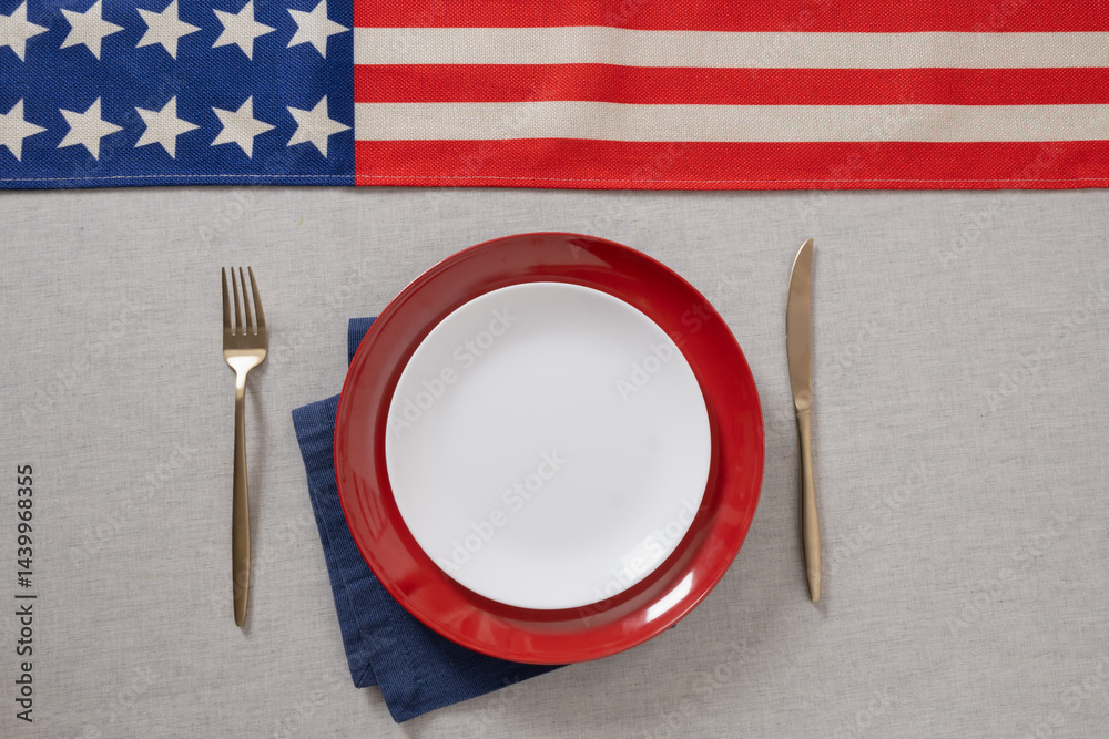 Table setting for USA Independence Day. Festive dinner with empty white plate and decoration in USA national flag colors red and blue. View from above. Copy space. Close up.