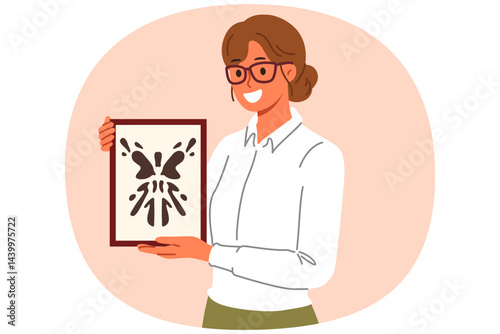 Rorschach test in hands of woman psychotherapist, want to find out psychological state patient with mental disorder. Girl psychotherapist with smile demonstrates abstract painting in form of blot.